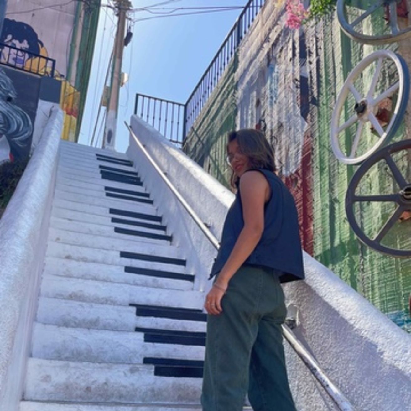 picture of a woman walking up stairs painted to look like piano keys