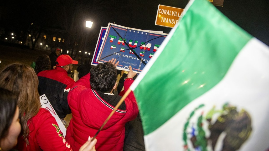 Demonstrators march during an immigration protest in downtown Iowa City on Friday, Feb. 3, 2025. Dozens of demonstrators danced, sang, chanted, and marched throughout the early evening. A handful of counter-protesters were in attendance.